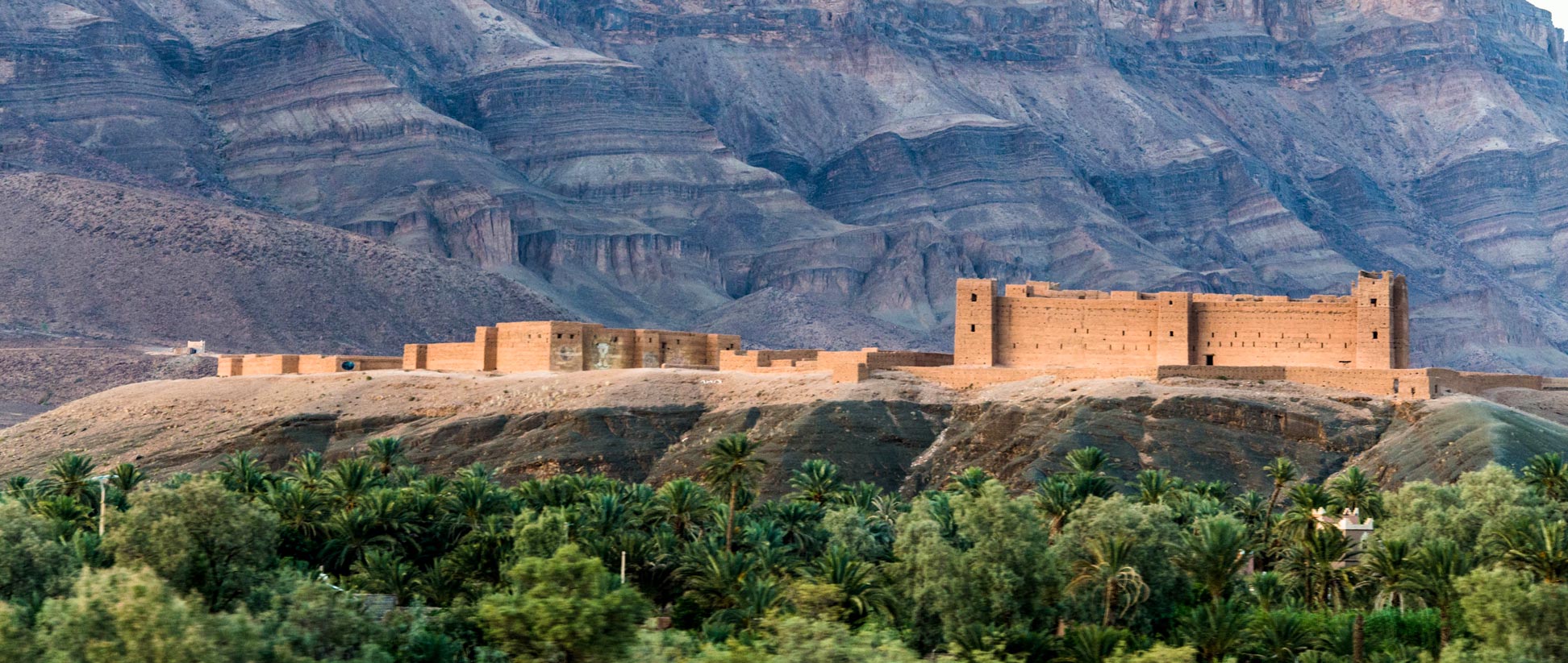 The kasbah of Tamnougalt is surrounded by palm trees of an oasis in the Atlas Mountains