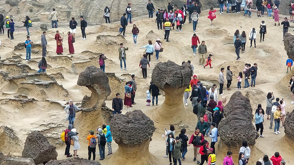 Hoodoo stones and tourists in Yehliu Geopark.