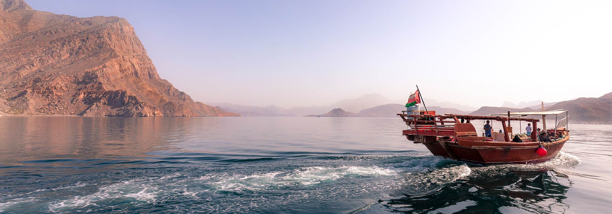 Dhow in a coastal scenery along Khor Ash Sham, Musandam Peninsula of Oman